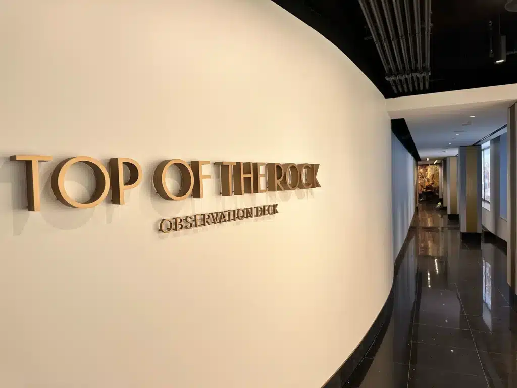 A curved hallway with a shiny black floor and 